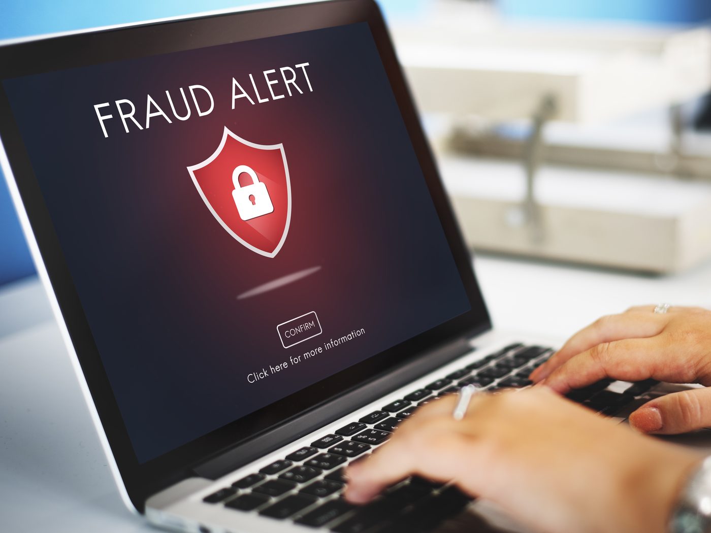 Person at a laptop encountering a phishing warning