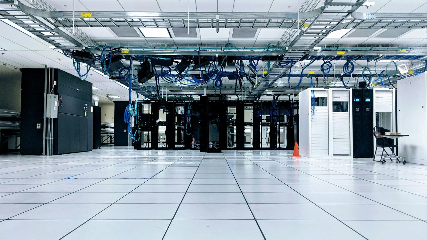 Black and white photograph of a data center aisle